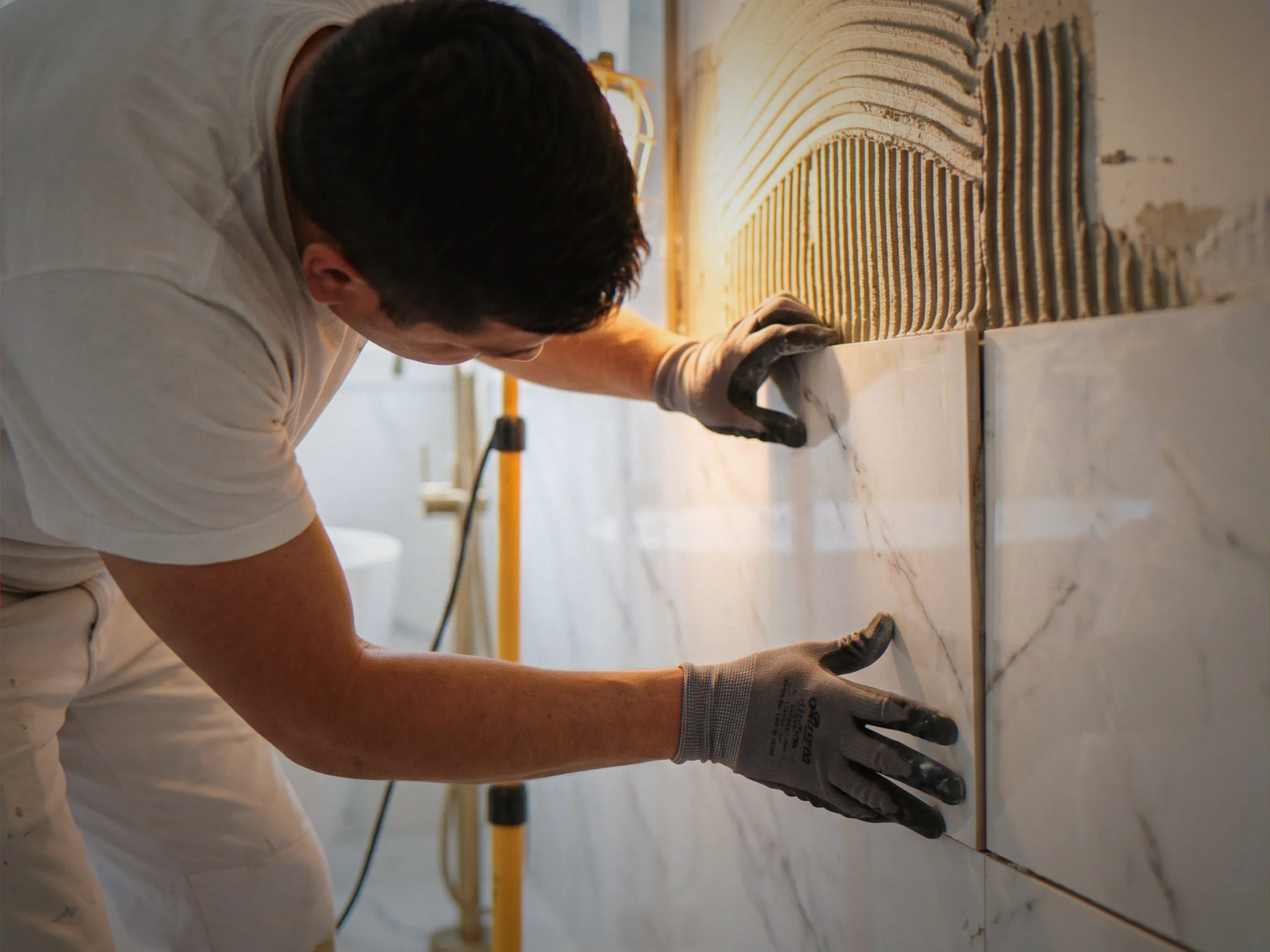 ViOrigin tile setter installing large format marble tile — bathroom remodel Seattle, WA