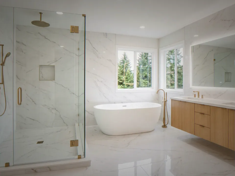Finished spa bathroom remodel with freestanding tub and frameless glass shower