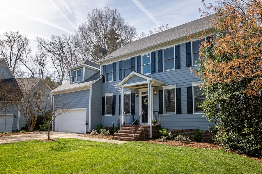 Two-story home with freshly painted fiber cement lap siding and black shutters