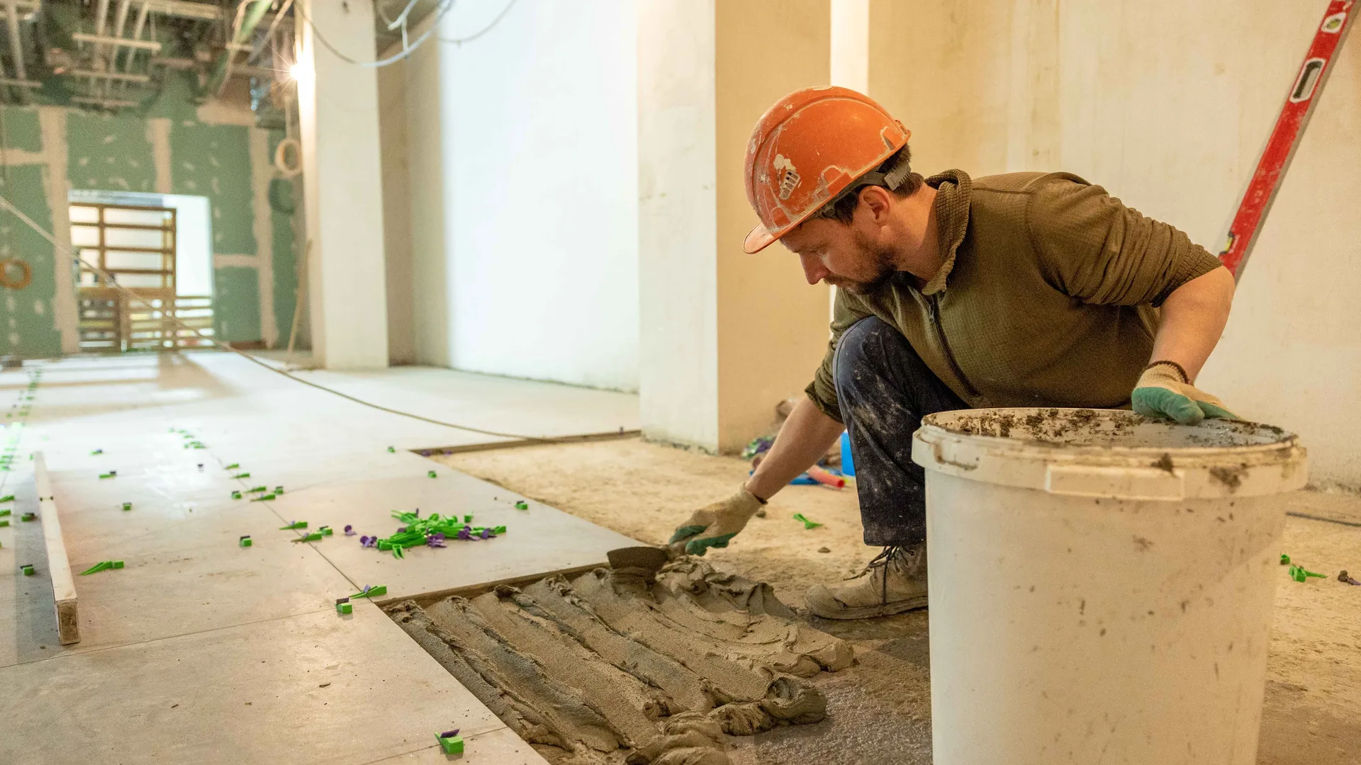 Tile contractor installing floor tile with thin-set mortar — Seattle & Bellevue, WA