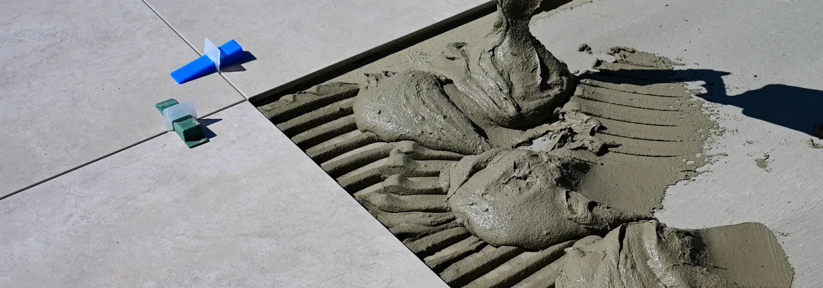 Notched trowel and thin-set mortar for custom tile work — Bellevue, WA